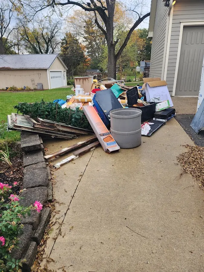 Dumpster being loaded with debris for Estate Cleanout Dumpster Rental in Wellington
